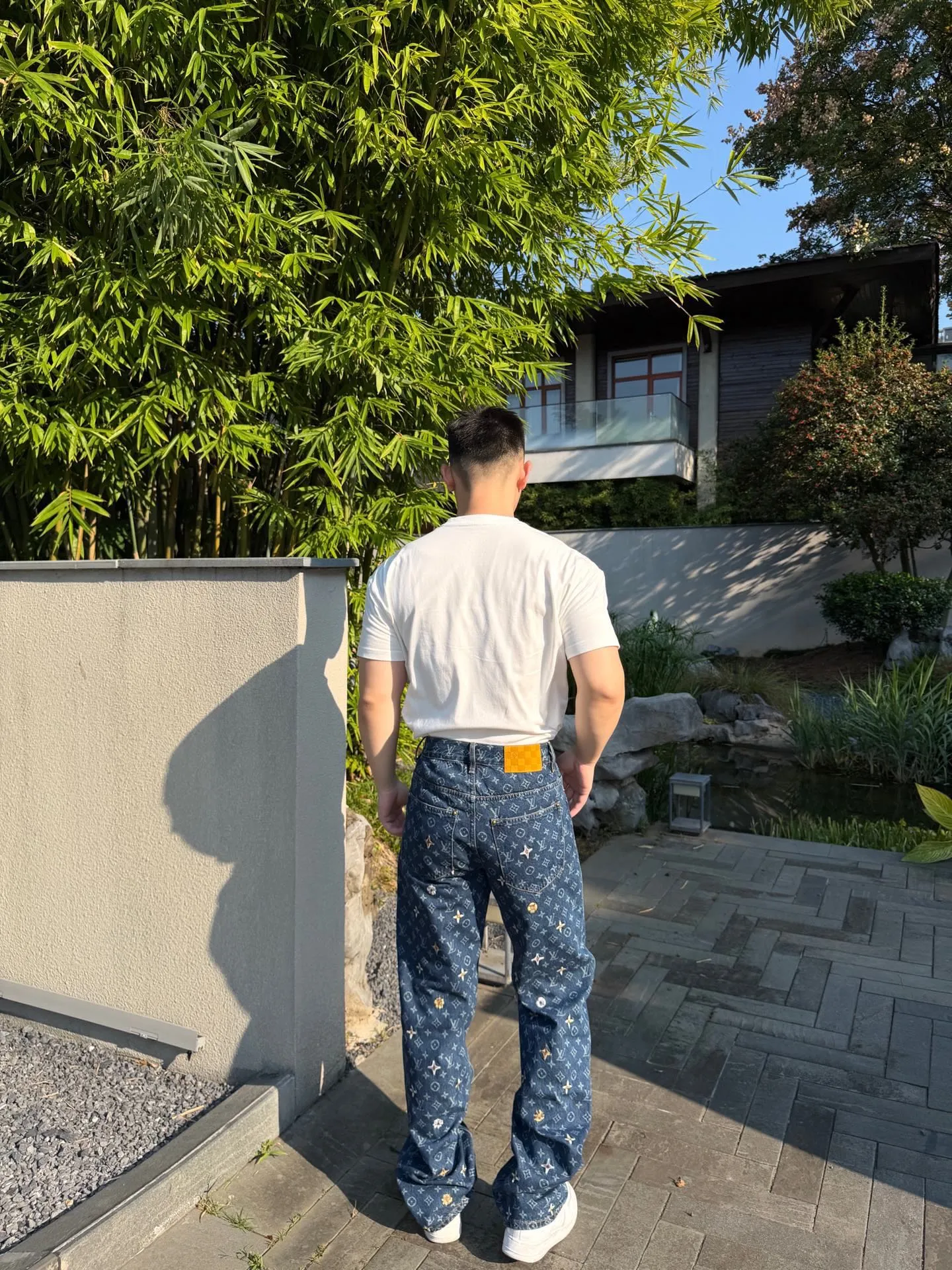 Louis Vuitton/Louis Vuitton all-over logo daisy embroidered jeans